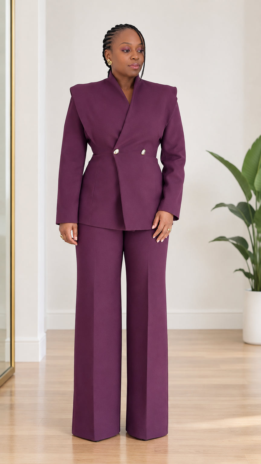 Front view of model wearing plum purple two-piece pantsuit with sculpted collar blazer and wide-leg trousers