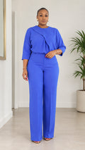 Front full view of woman wearing Royal Blue asymmetrical draped blouse and wide-leg trousers set