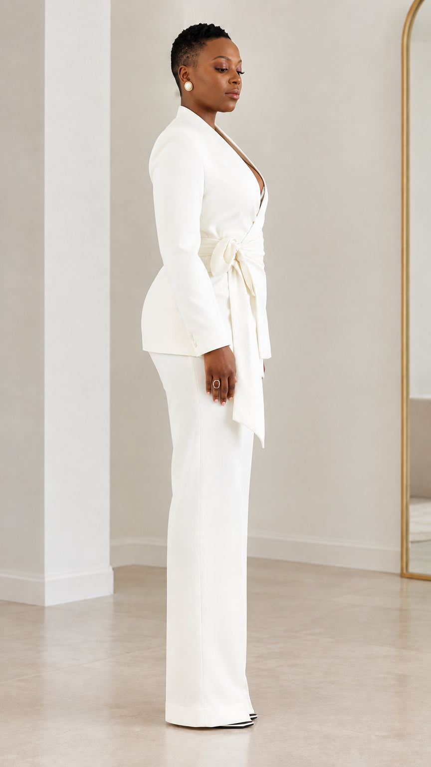 Side profile view of model wearing white tailored wrap pantsuit