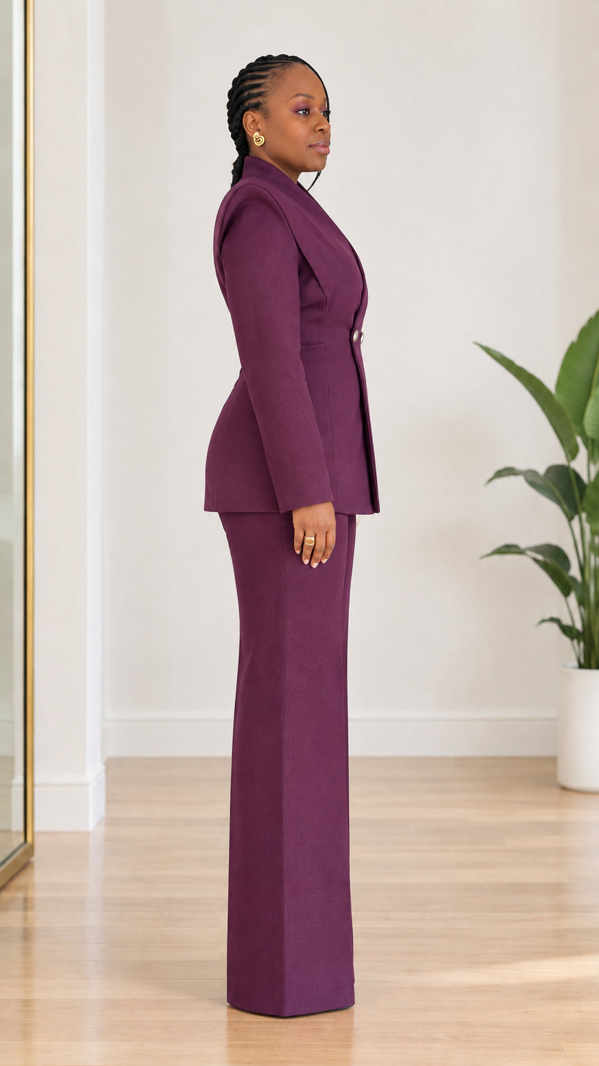 Side profile of model wearing tailored plum purple blazer and matching wide-leg trousers