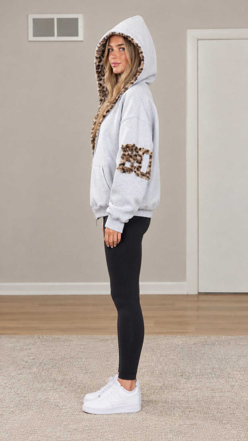 Side profile view of woman modeling Light Grey oversized zip-up hoodie