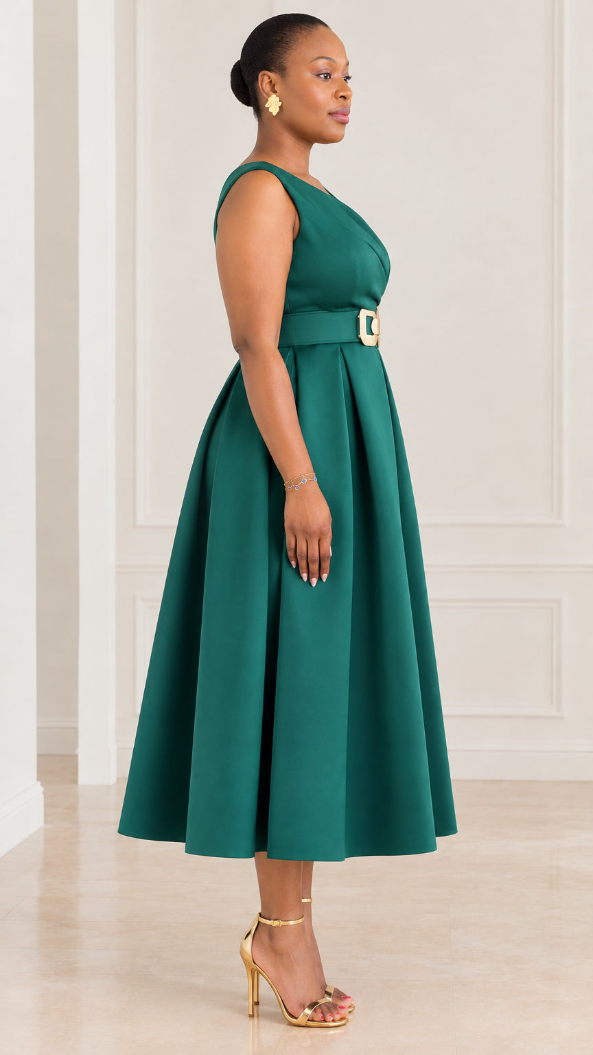Side profile view of woman wearing emerald green pleated A-line cocktail midi dress