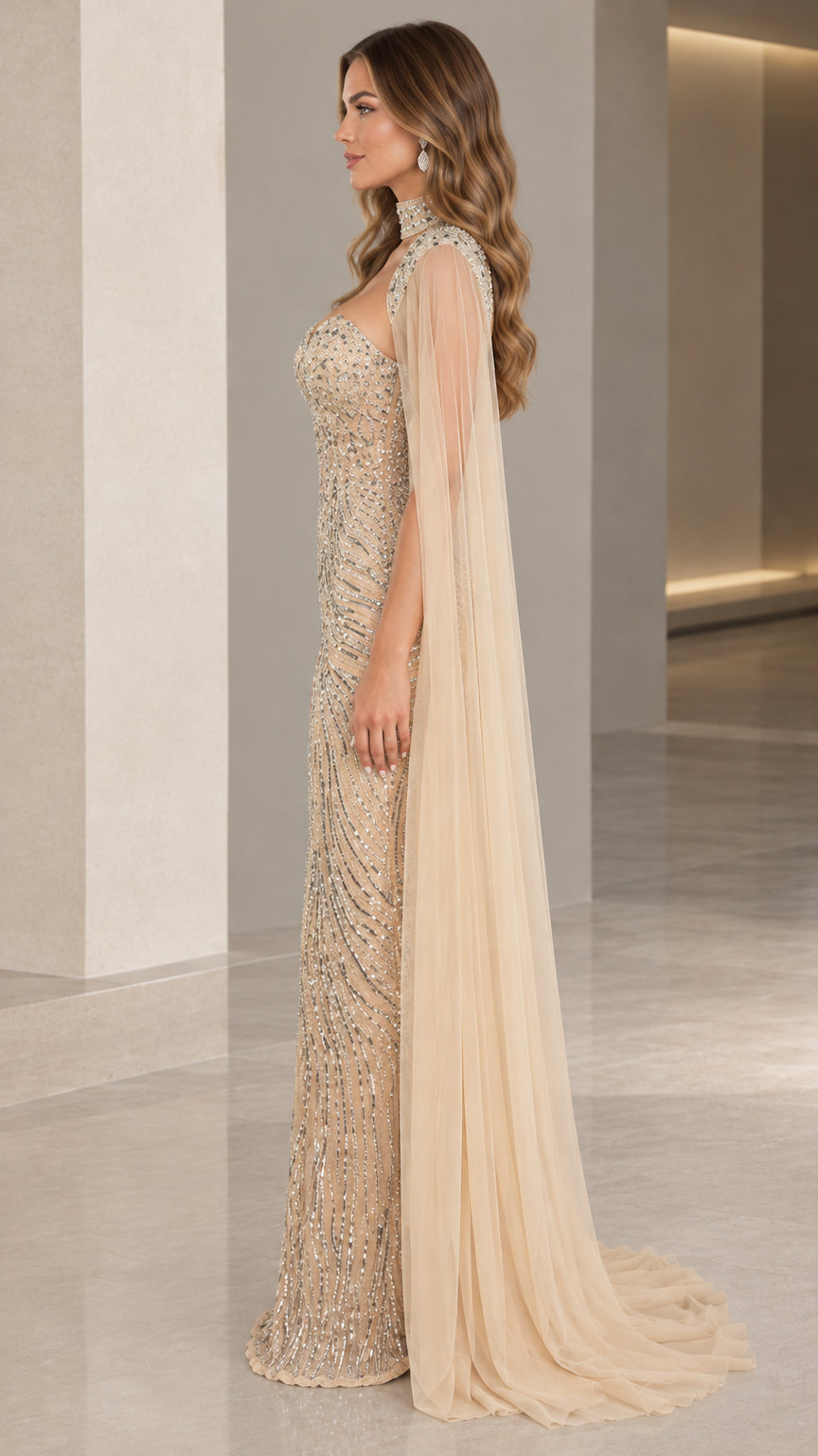 Side profile of champagne beaded formal dress with trailing sheer cape sleeves