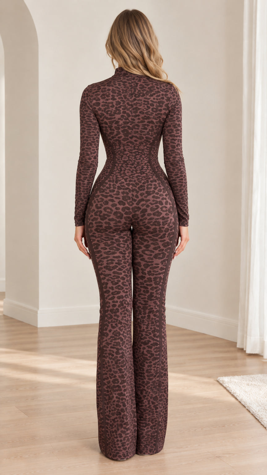 Back view of model wearing brown leopard print long sleeve flared jumpsuit