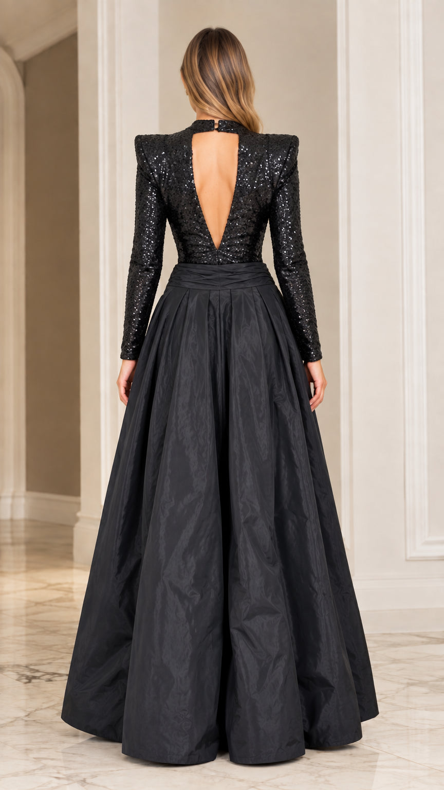 Back view of black sequined gown highlighting open cutout back and floor length skirt