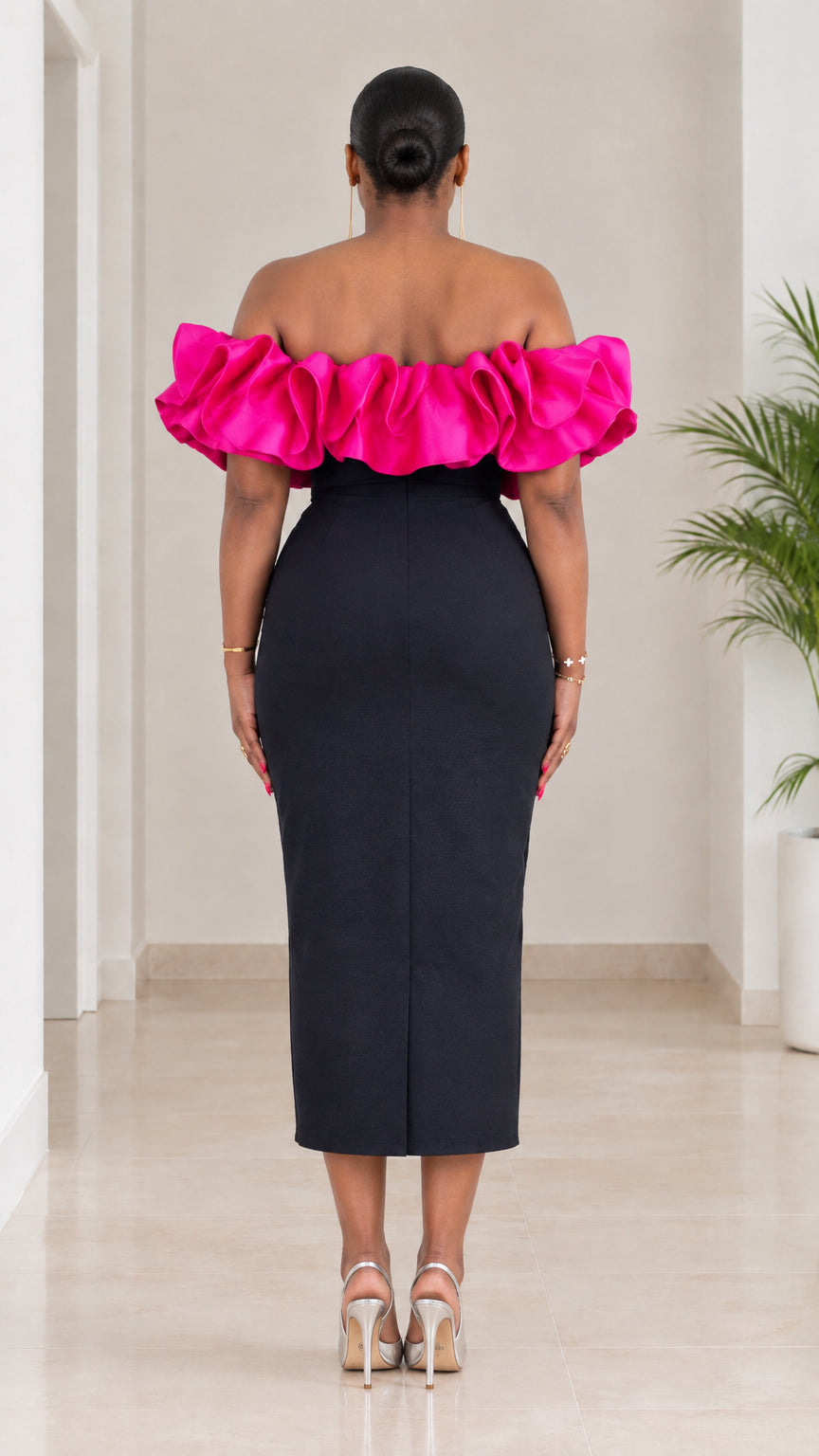 Back view of black and fuchsia ruffled midi pencil dress with center slit