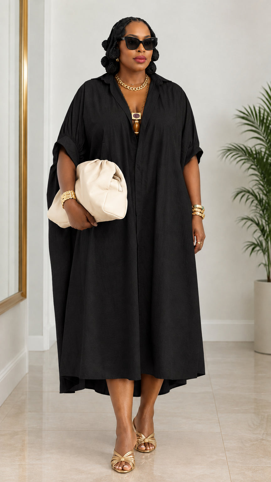 Woman wearing black oversized lapel collar kaftan shirt dress with clutch