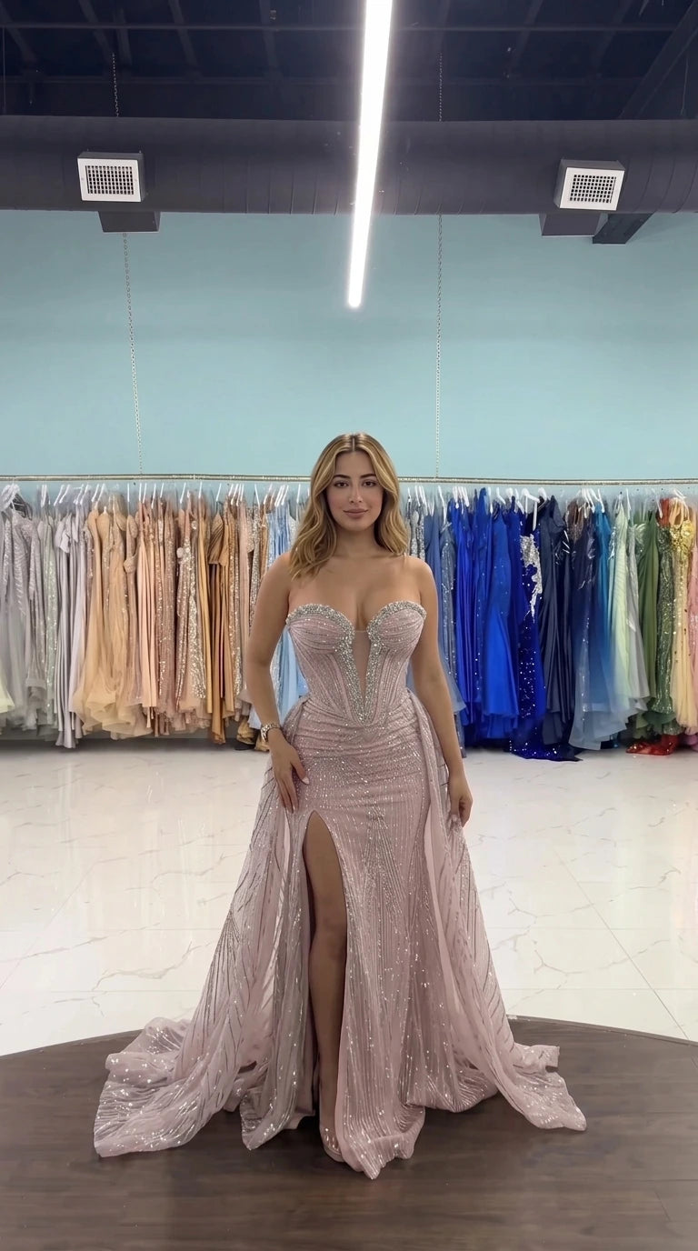 Front view of woman wearing dusty rose strapless corset evening gown with train
