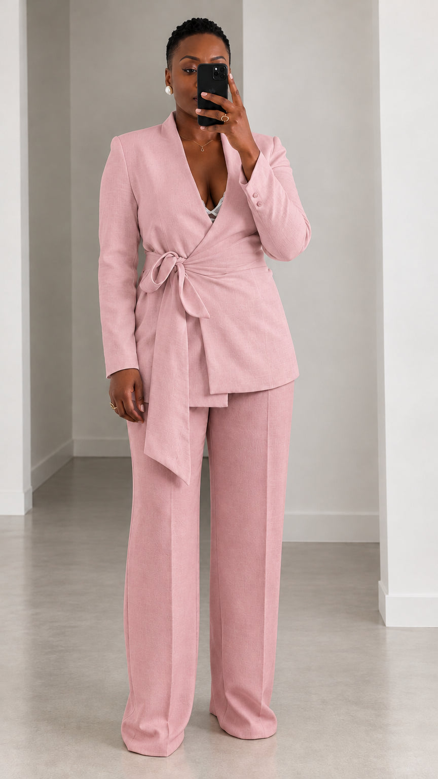 Model wearing dusty pink wrap blazer and matching wide leg trousers suit set