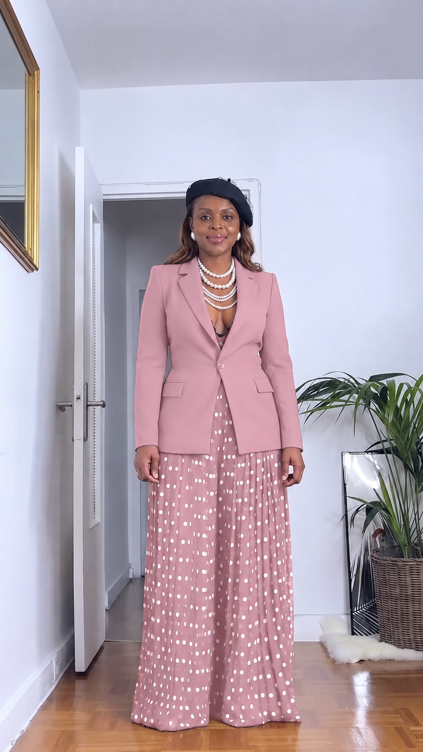 Front full view of woman wearing dusty pink tailored blazer and pink polka dot pleated wide leg pants