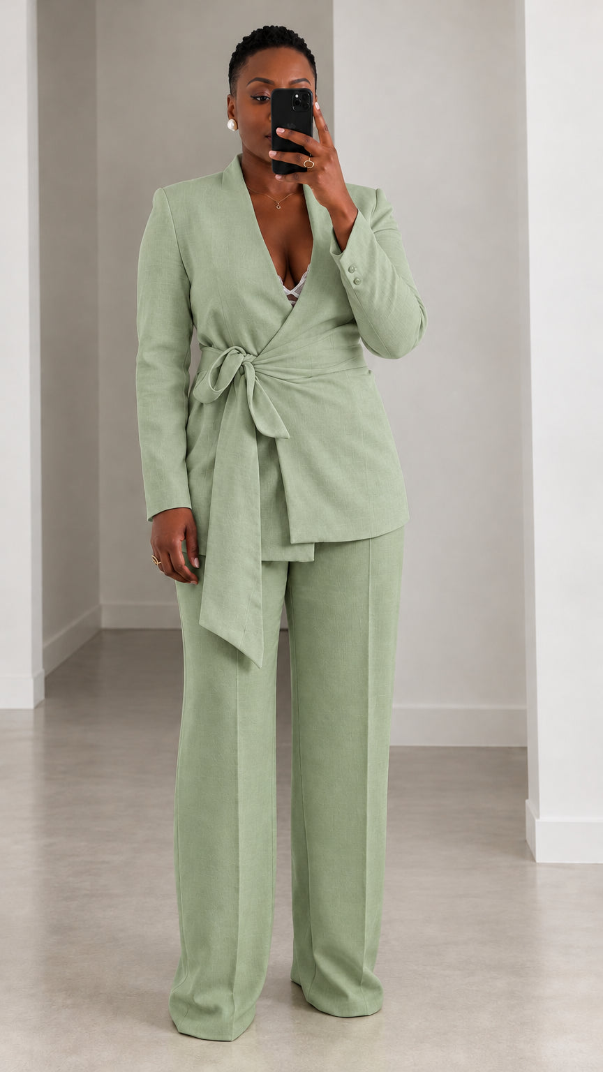 Model wearing sage green wrap blazer and matching wide leg suit trousers
