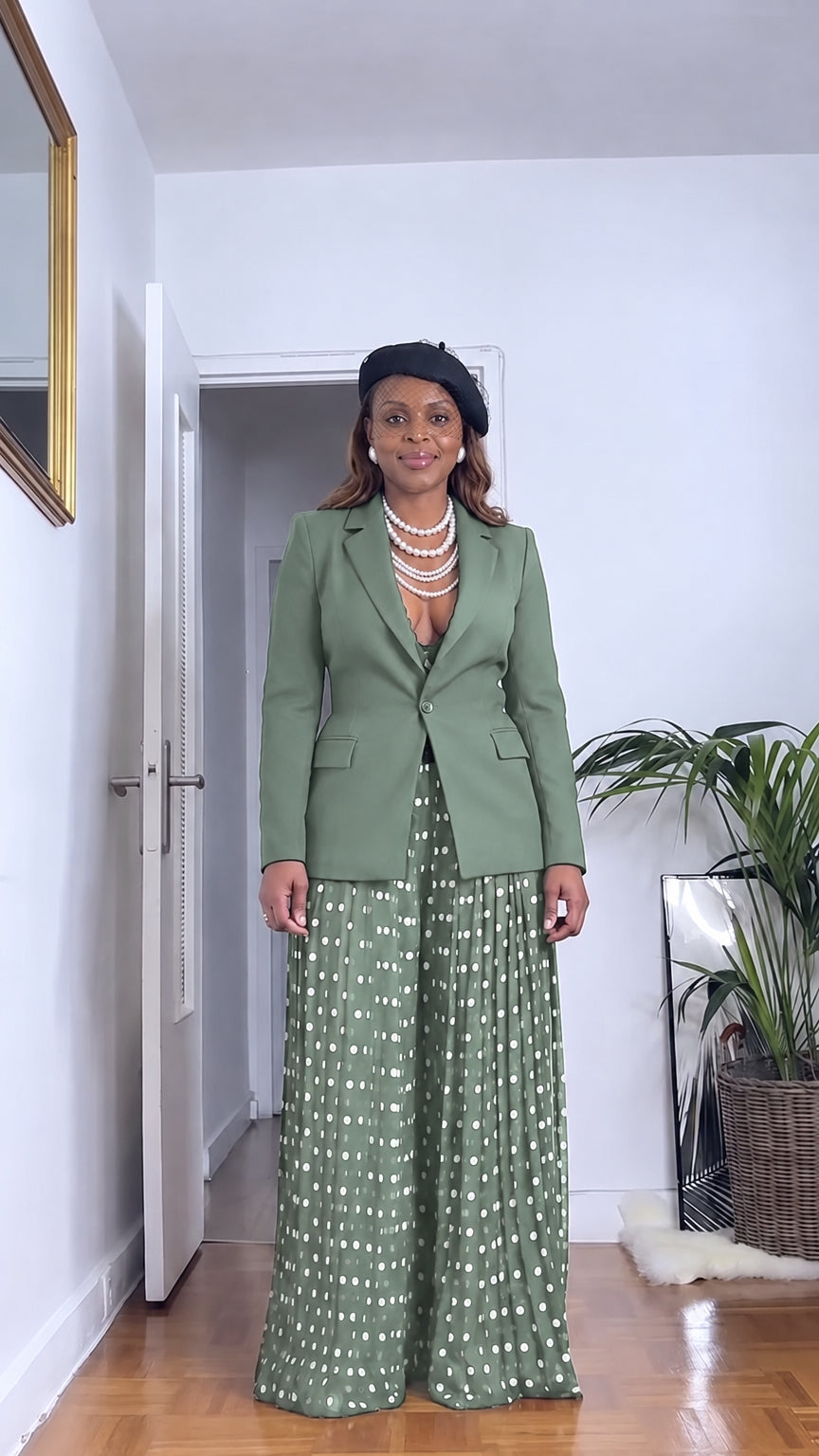 Front full view of woman wearing sage green tailored blazer and sage polka dot pleated wide leg pants