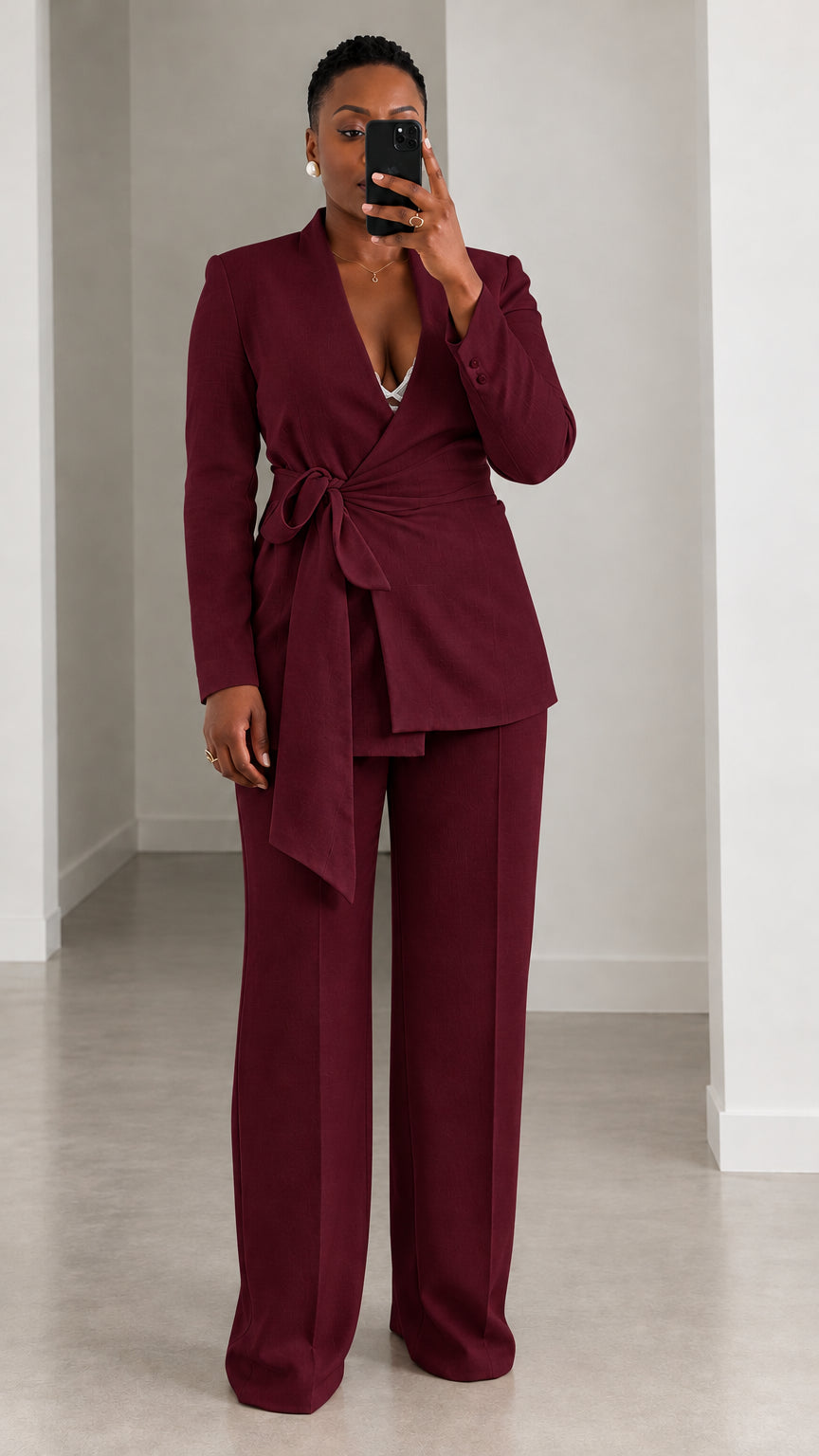 Model wearing deep burgundy wrap blazer and matching wide leg pants suit set